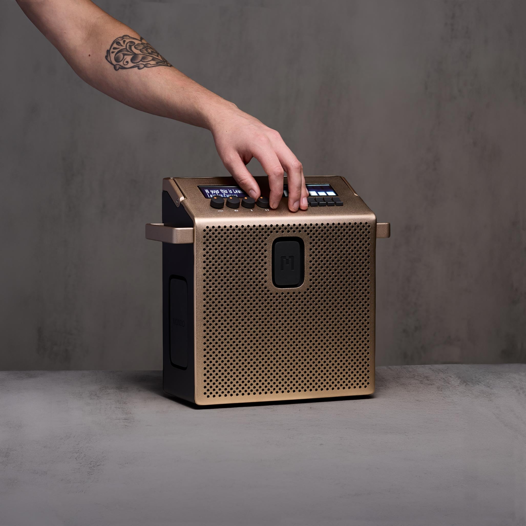 Speaker_M_Brass_Concrete_Hand.jpg
